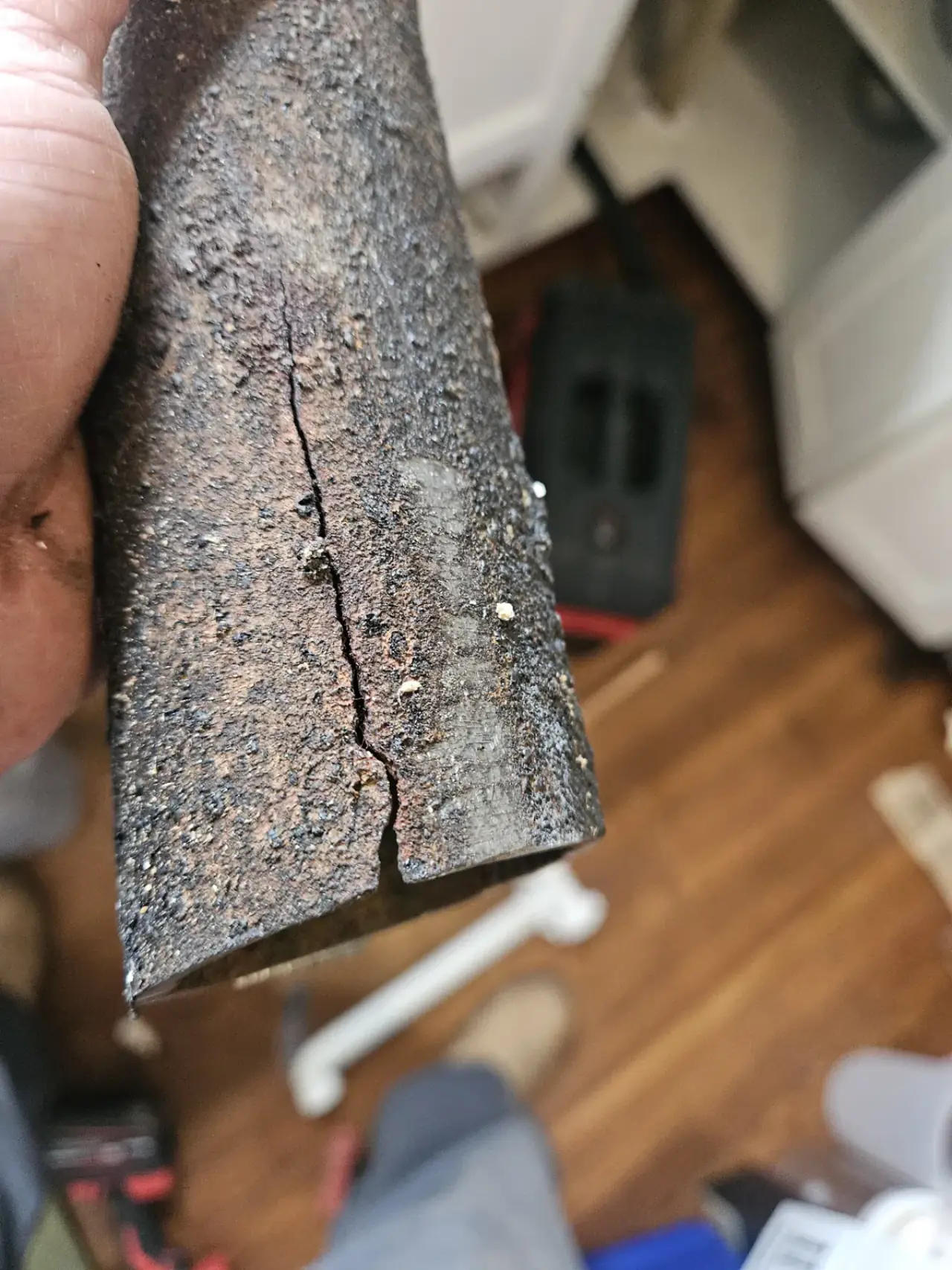 Cracked cast iron drain pipe removed from an East Texas home