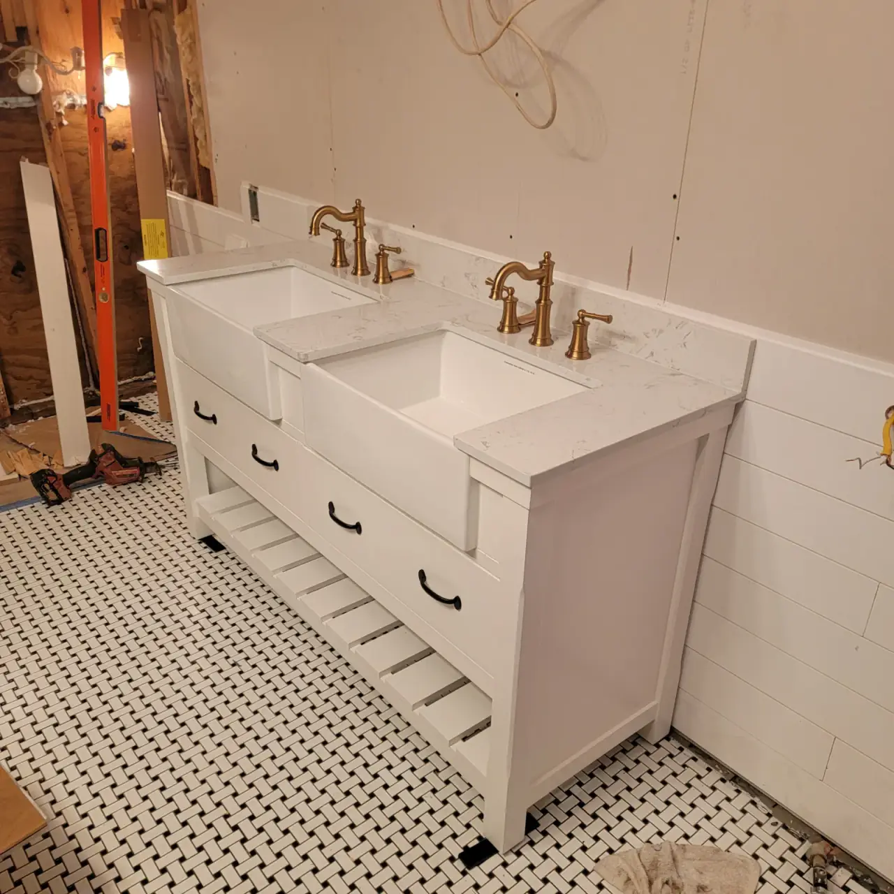 Double vanity with brass fixtures installed during a bathroom remodel in East Texas