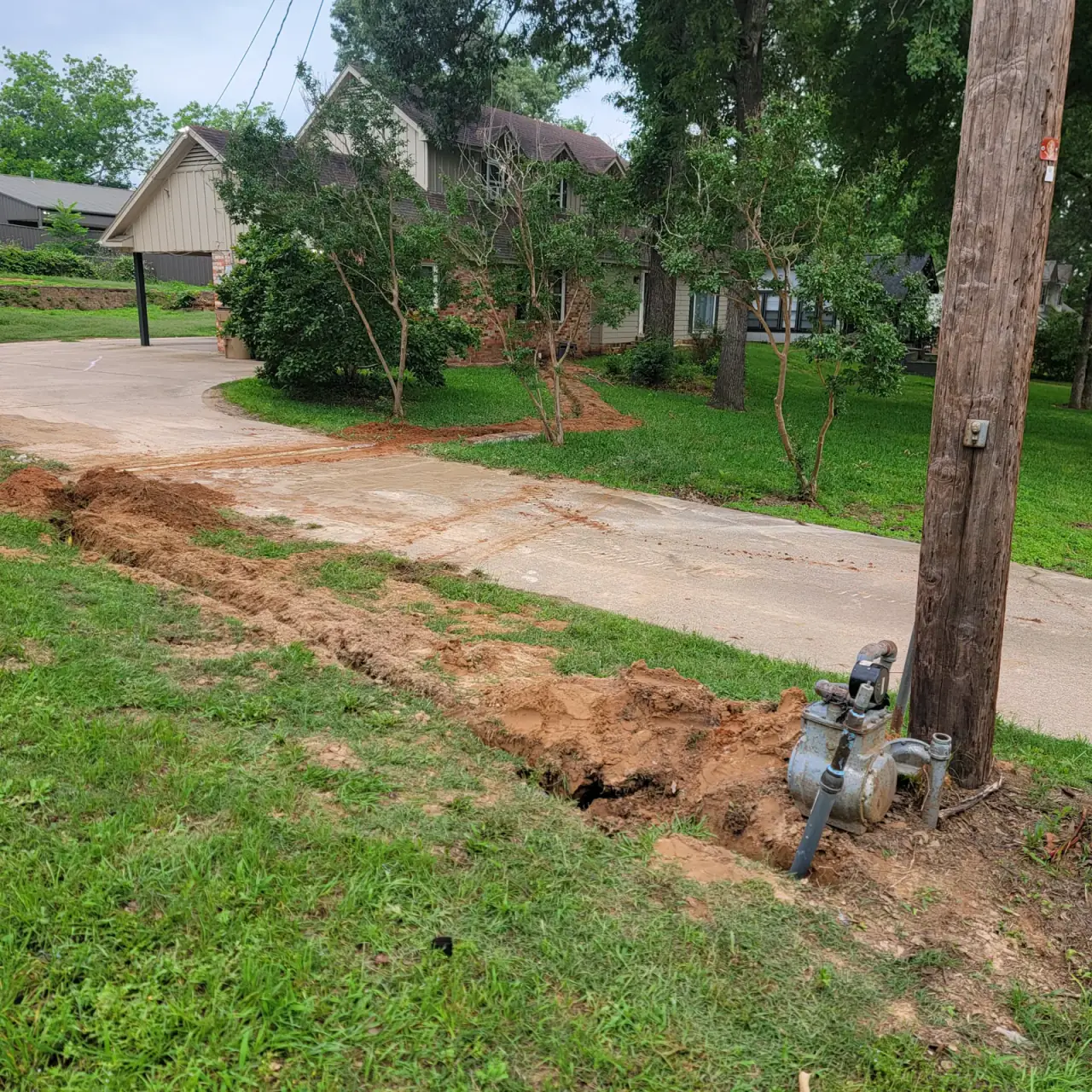 Utility line trench cut across a driveway approach in East Texas