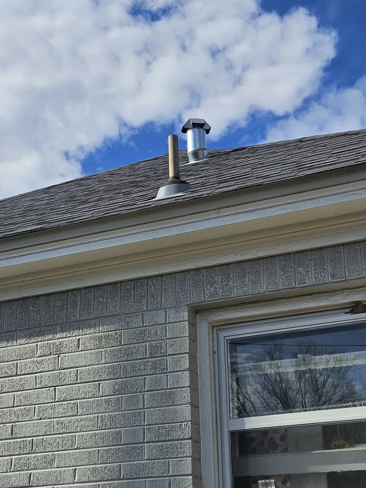 New water heater flue and roof vent installed on an East Texas home