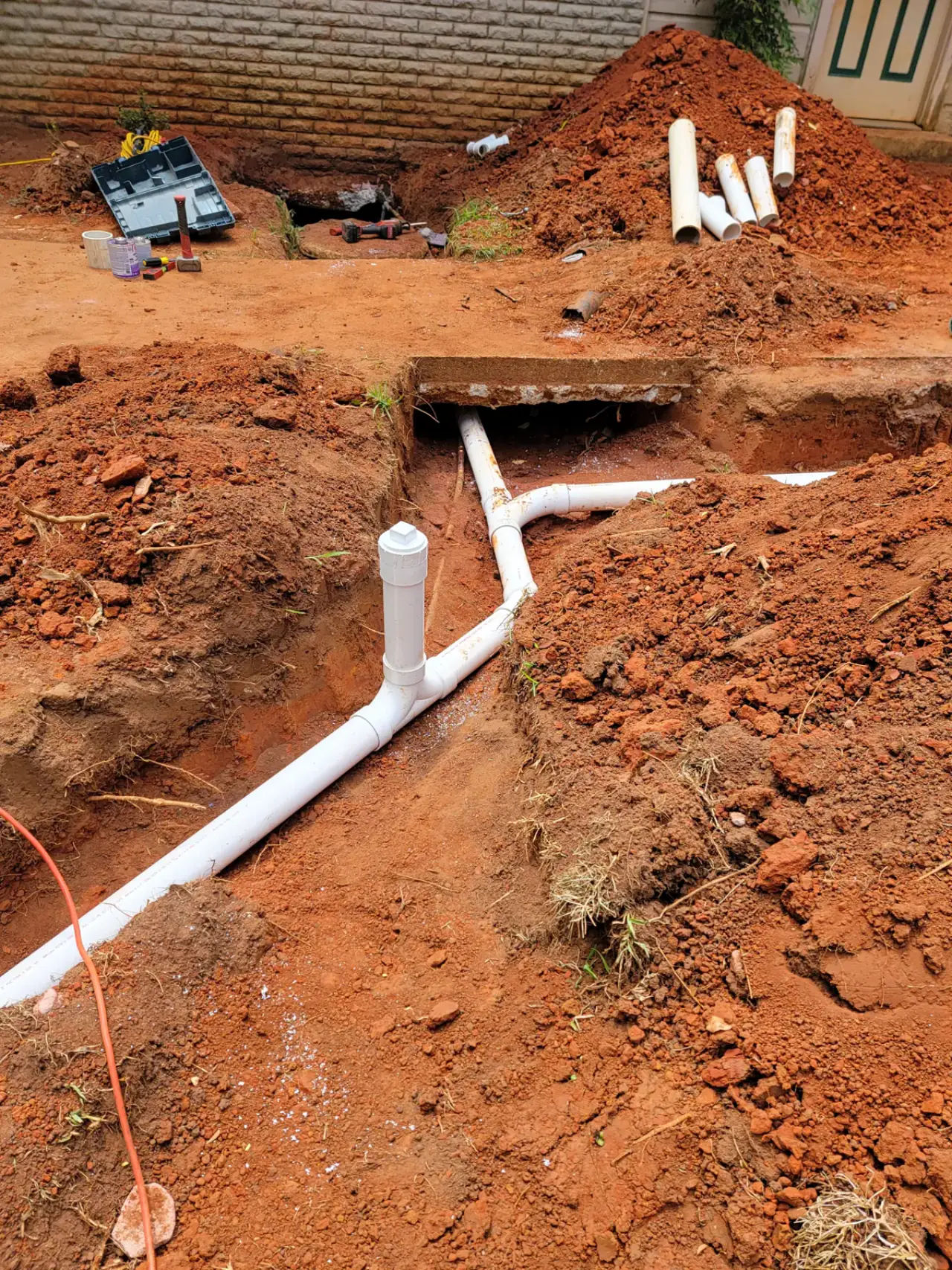 New PVC sewer line laid in an open trench by Odyssey Plumbing Co in East Texas