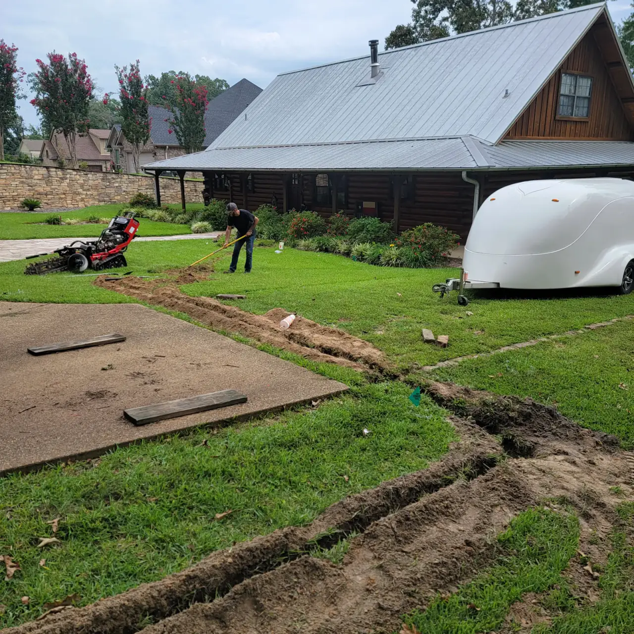 Trenching a new water line to a log home in East Texas