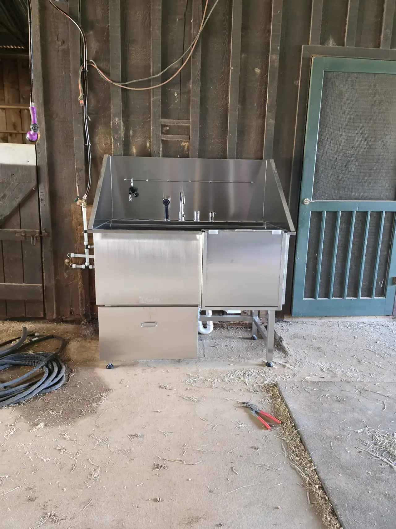Stainless utility wash station installed in a barn in East Texas